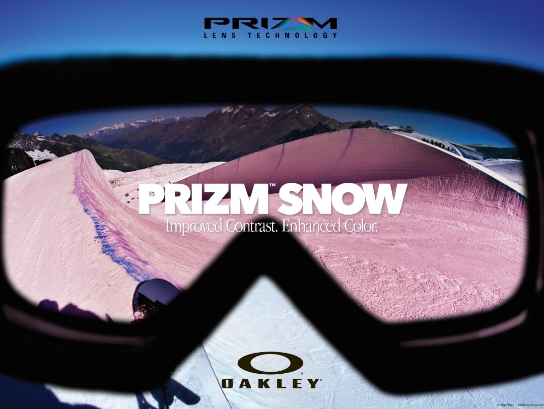 A pair of black goggles with a picture of the snow and mountains reflected in the lenses.