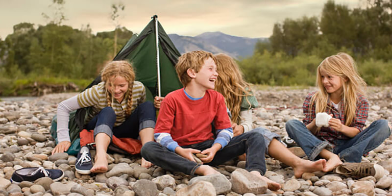 Three girls and a boy camping